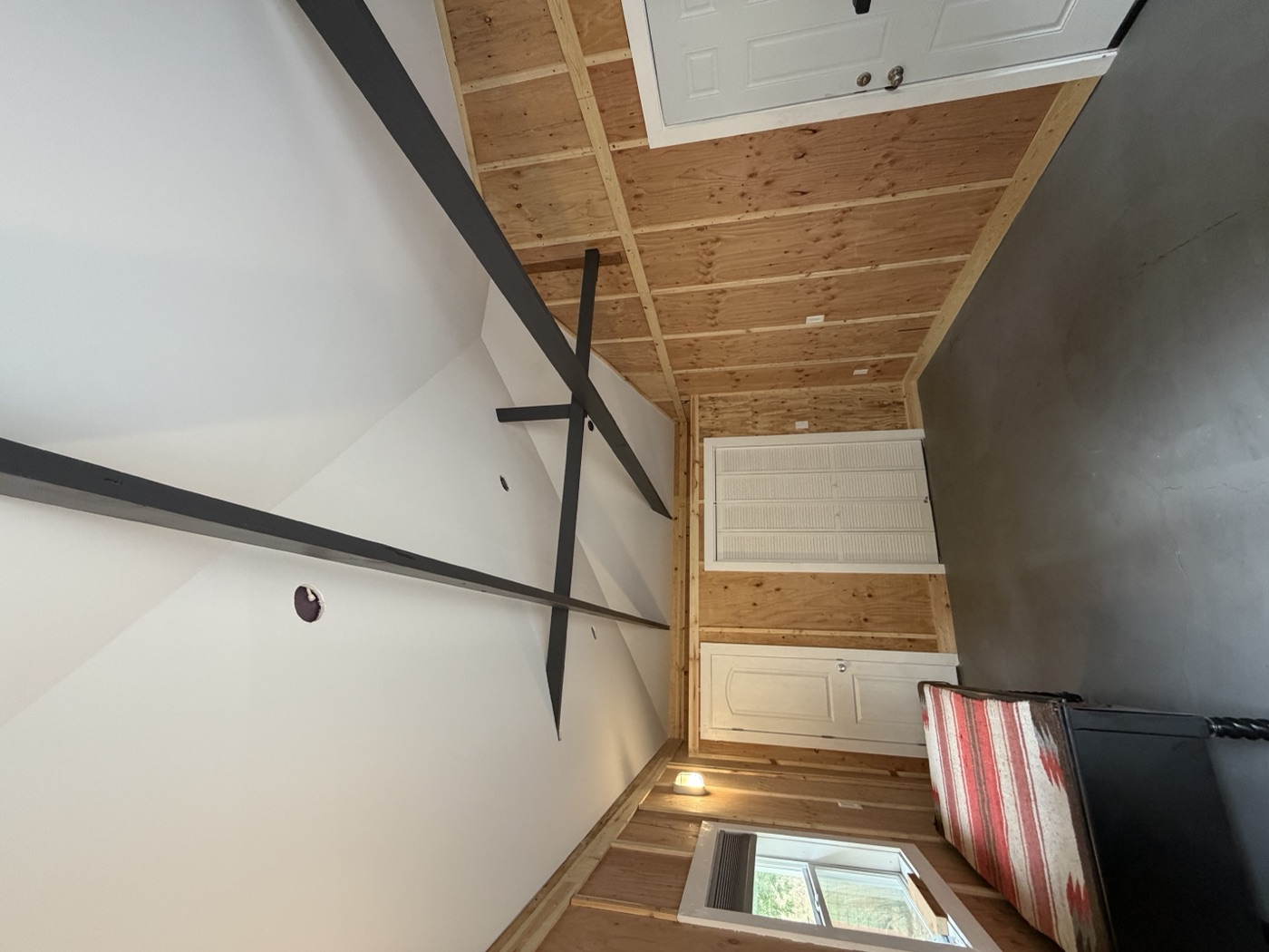 Cabin interior after renovation with finished drywall, paint, and built-in storage